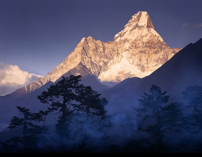 This is the classic and most familiar view of Ama Dablam, a 23,000 foot peak the towers over the trail to Everest Base Camp. The mist you see here is actually smoke coming from a yak-dung burning stove at the famous Tengboche Monastery which sits high on this ridge. Mt Everest is obscured by the big cloud in the left corner.